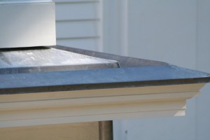 A view of a built-in gutter on a Greek Revival home